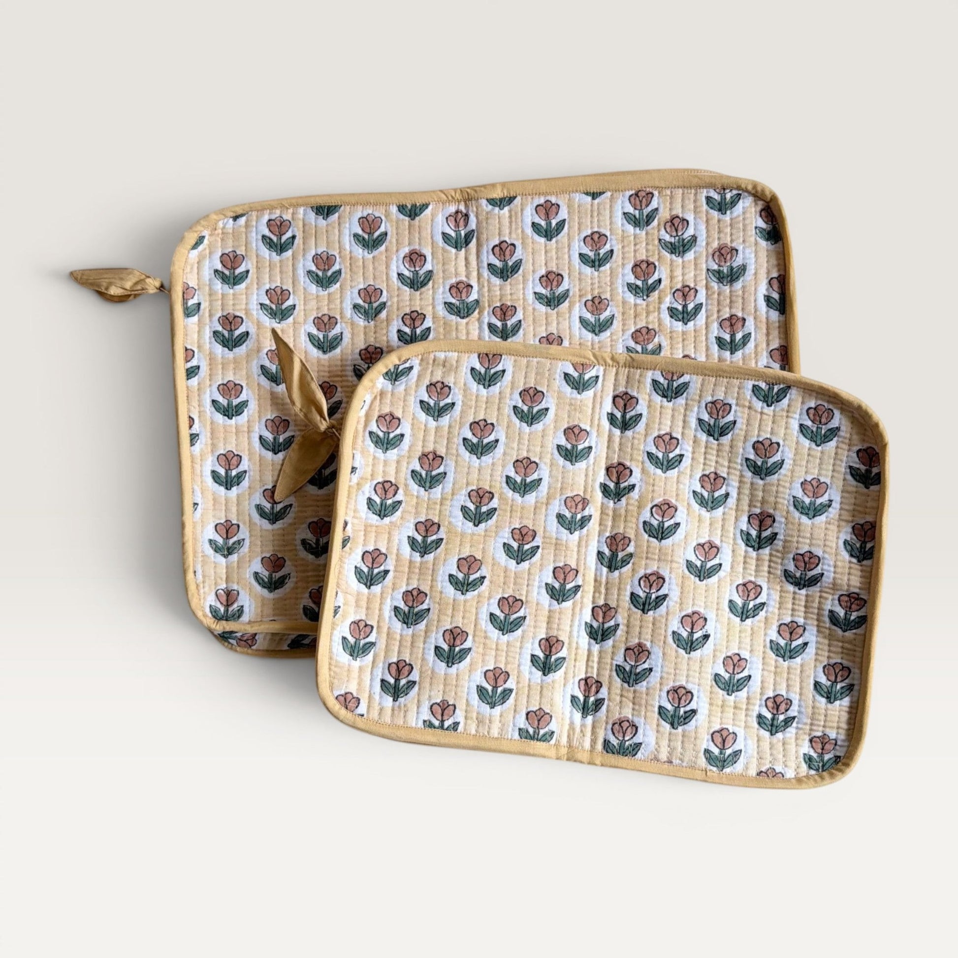 The Block & Bloom quilted laptop sleeve in golden yellow with rust tulip print and hand-stitched fabric bow zipper.