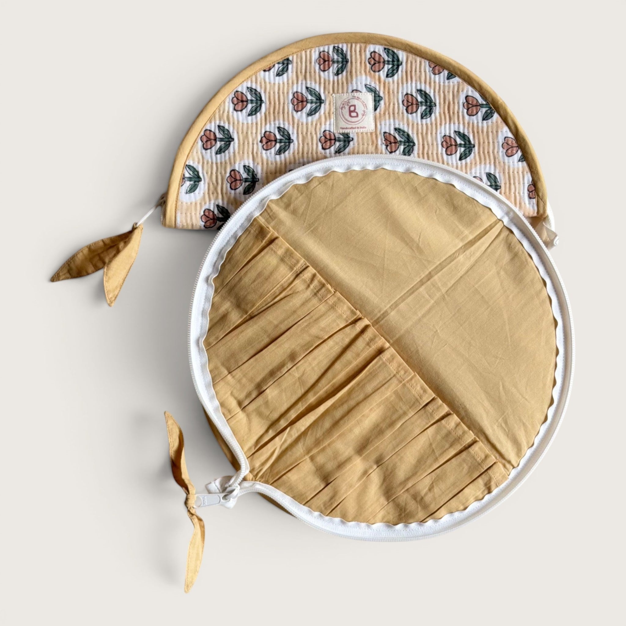 The Block & Bloom quilted makeup brush pouch in golden yellow with a rust tulip print and internal brush slots.