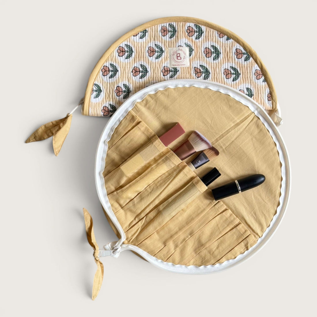 The Block & Bloom quilted makeup brush pouch in golden yellow with a rust tulip print and cotton fabric.