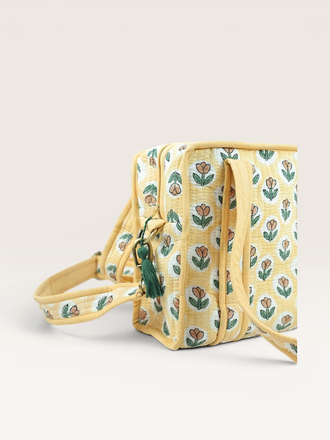 The Block & Bloom quilted mini tote in golden yellow with rust tulip block print, padded handles, and crossbody strap.