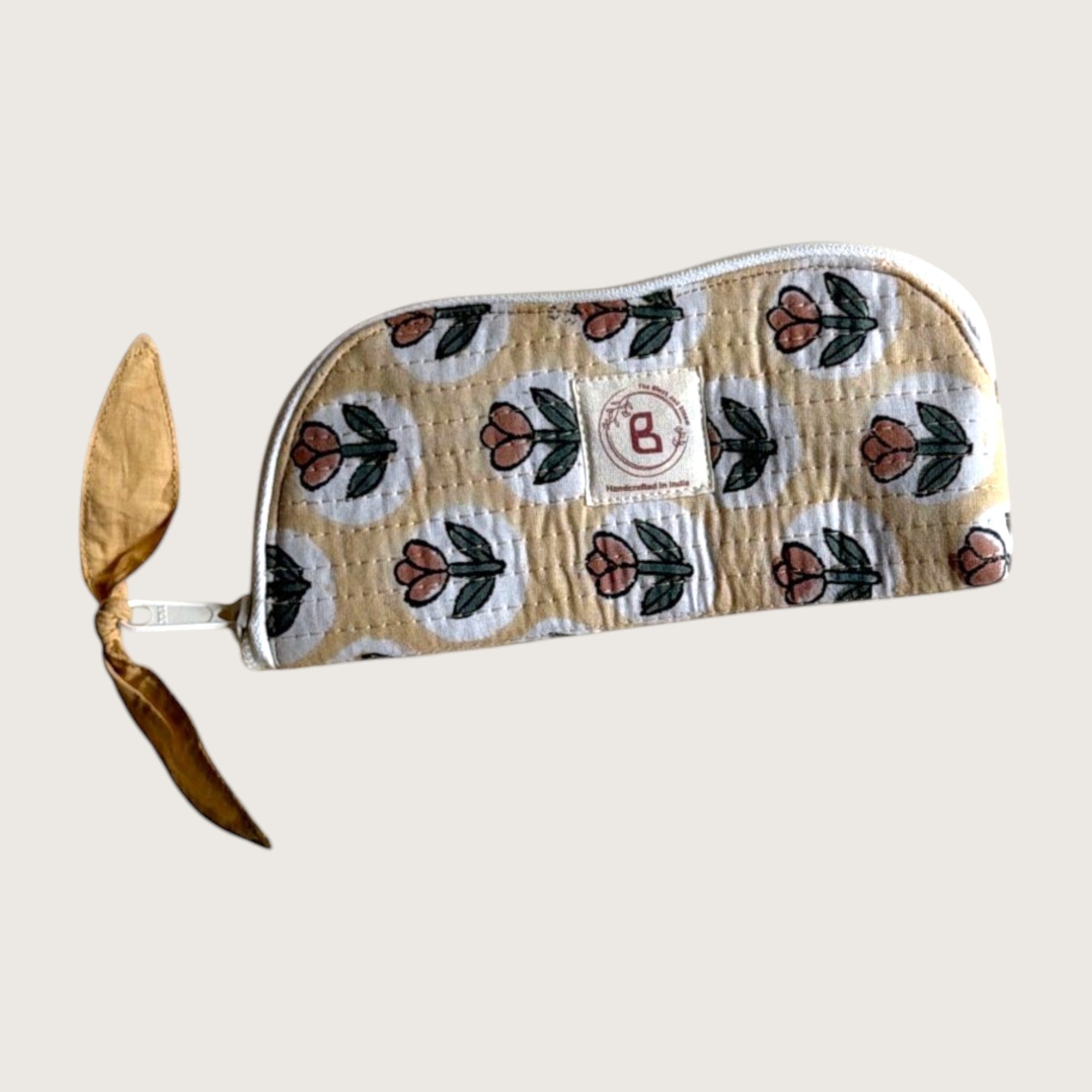The Block & Bloom quilted cotton sunglasses pouch in golden yellow with a rust tulip print and a fabric zipper pull.