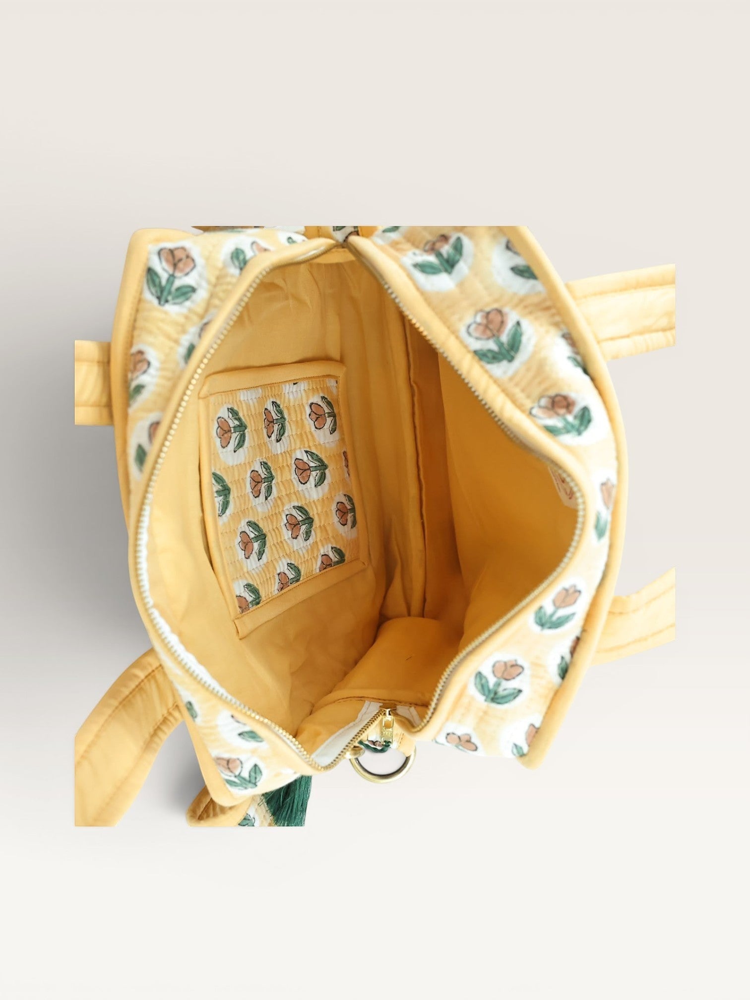 The Block & Bloom quilted mini tote in yellow with rust tulip print, showing the open interior and inner pocket.
