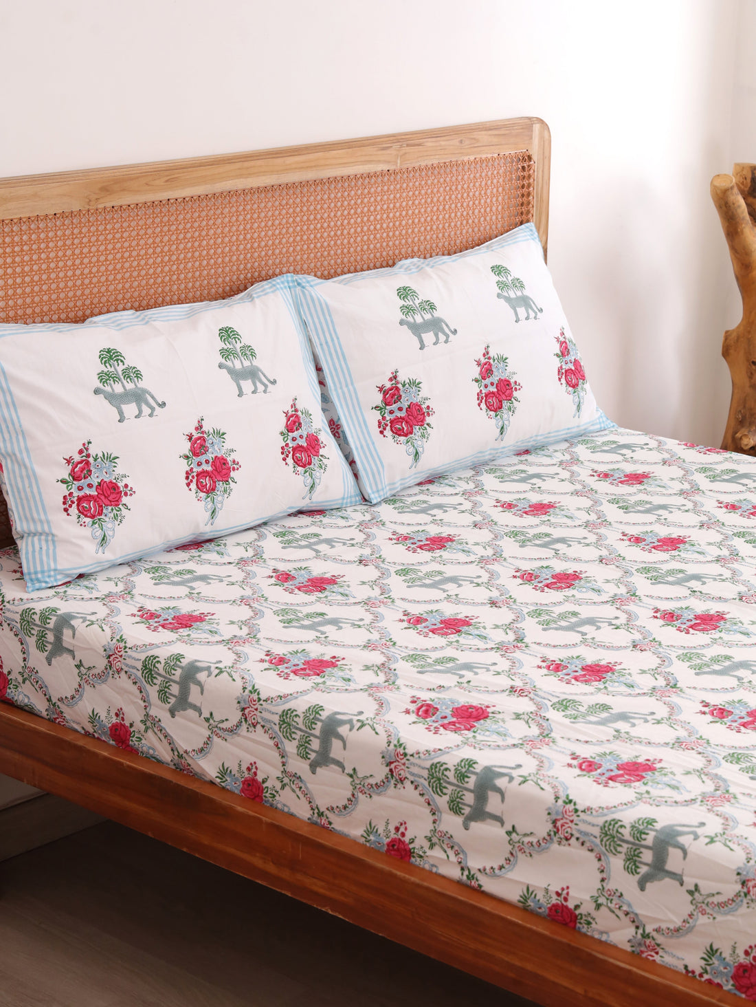 The Block & Bloom Royal Bagh cotton fitted sheet and pillowcases with cheetah, palm, and pink rose block print.