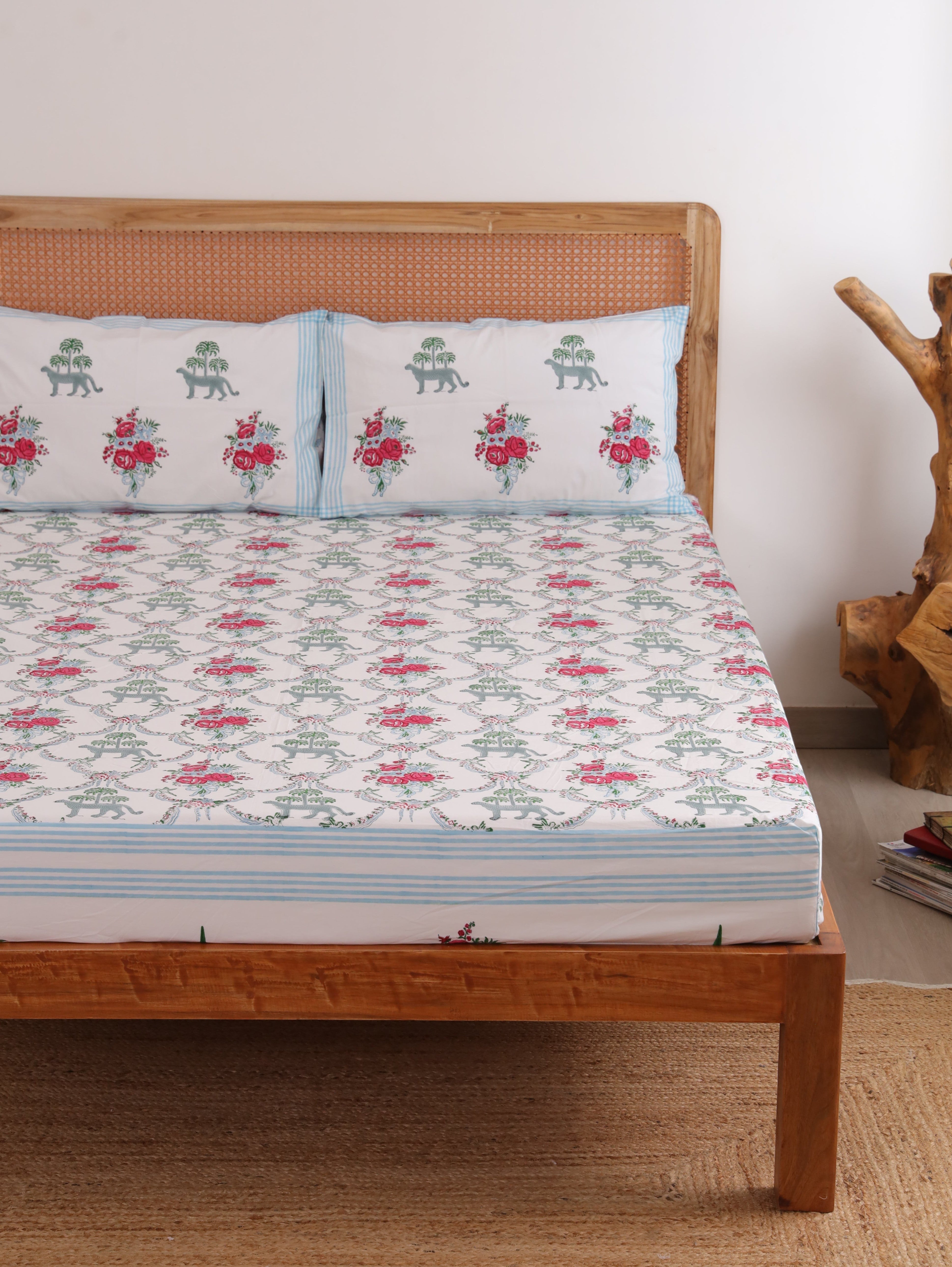 The Block & Bloom Royal Bagh cotton fitted sheet and pillowcases with cheetah, palm, and rose hand block print.