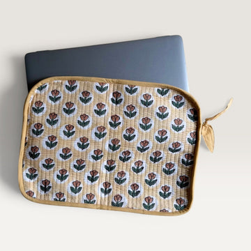 The Block & Bloom quilted laptop sleeve in yellow with rust tulip block print, featuring a YKK zipper and fabric bow.
