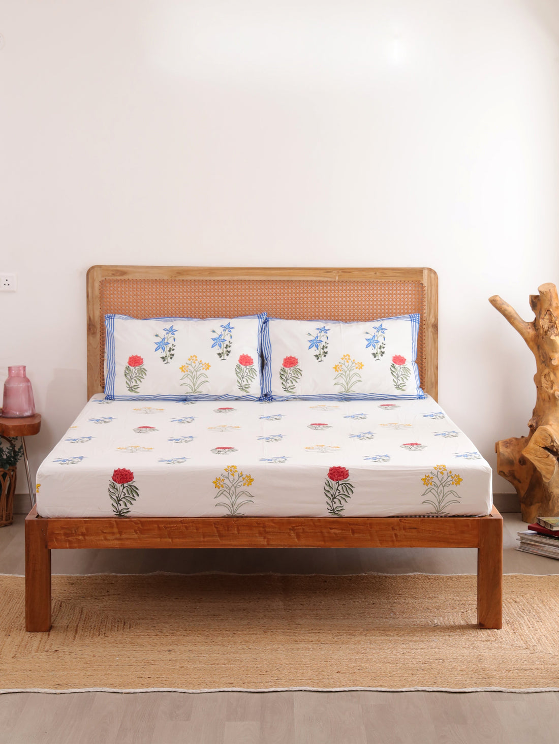 The Block & Bloom Wildflower Bagh cotton fitted sheet and pillowcases with blue, pink, and yellow floral block prints.